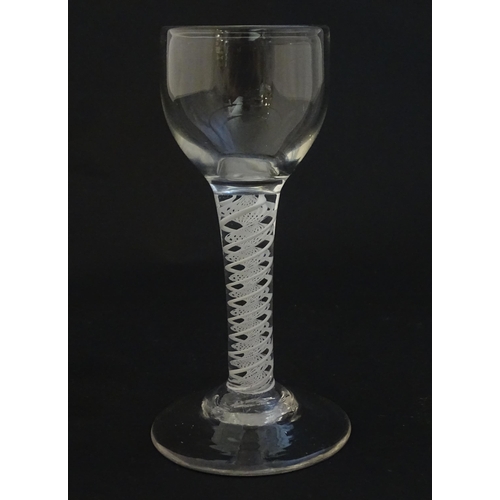 229 - A 19thC pedestal drinking glass with twist detail to stem. Approx 5