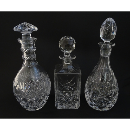 240 - Three various cut crystal /  glass decanters. The tallest approx 12 1/4