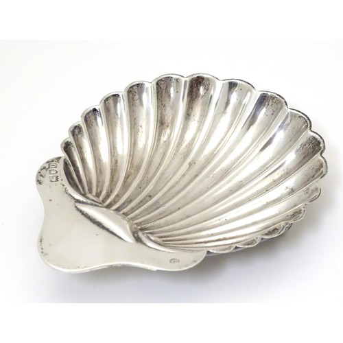 326 - A silver butter dish of shell form. Hallmarked London 1915 maker Josiah Williams & Co (David Landsbo... 