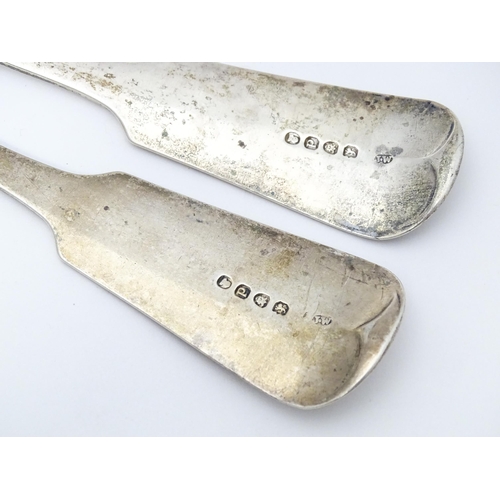 265 - A pair of Geo III silver fiddle pattern basting / serving spoons. Hallmarked London 1819 maker J.W a... 