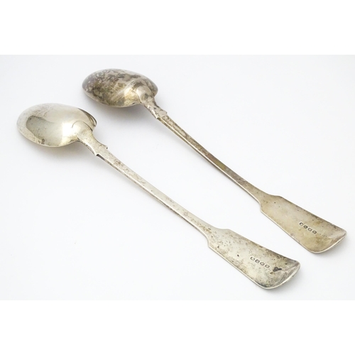 265 - A pair of Geo III silver fiddle pattern basting / serving spoons. Hallmarked London 1819 maker J.W a... 