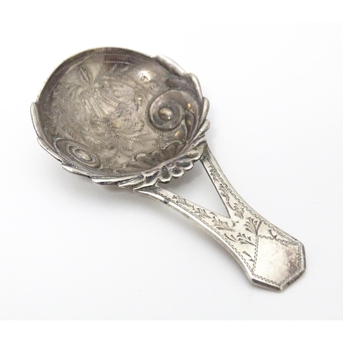 266 - A Geo III silver caddy spoon with engraved decoration and bifurcated handle . Hallmarked Birmingham ... 