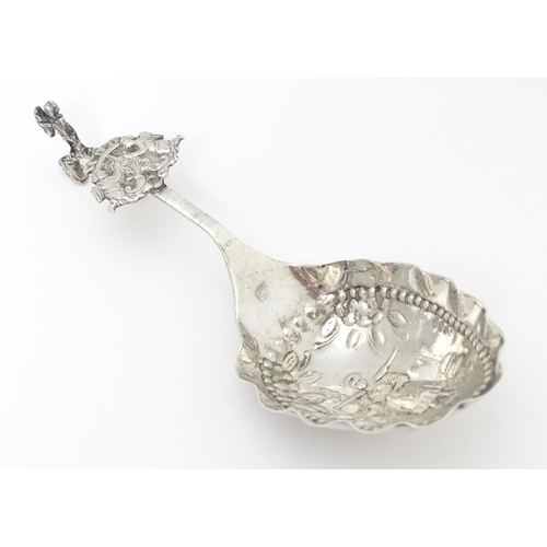 275 - A Dutch silver caddy spoon with embossed decoration. Approx. 4 3/4