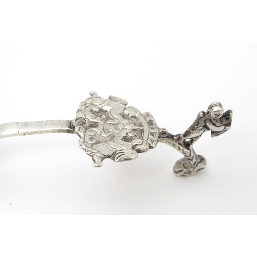 275 - A Dutch silver caddy spoon with embossed decoration. Approx. 4 3/4