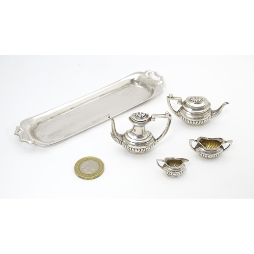 281 - A silver 5 piece miniature / dolls house tea set comprising tea pot, coffee pot, sugar bowl and crea... 