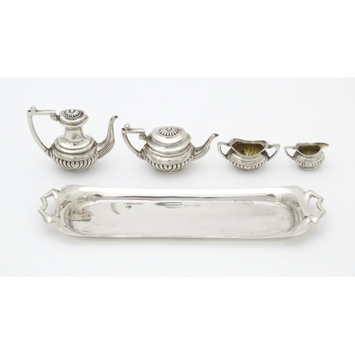 281 - A silver 5 piece miniature / dolls house tea set comprising tea pot, coffee pot, sugar bowl and crea... 