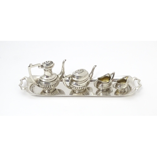 281 - A silver 5 piece miniature / dolls house tea set comprising tea pot, coffee pot, sugar bowl and crea... 