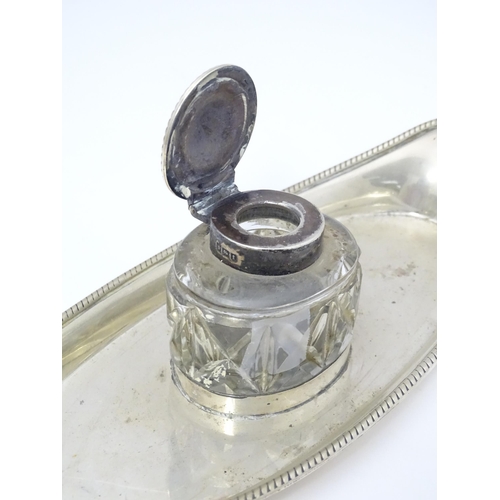 284 - A silver standish, hallmarked London 1910 maker William Hutton & Sons and having a glass ink bottle ... 