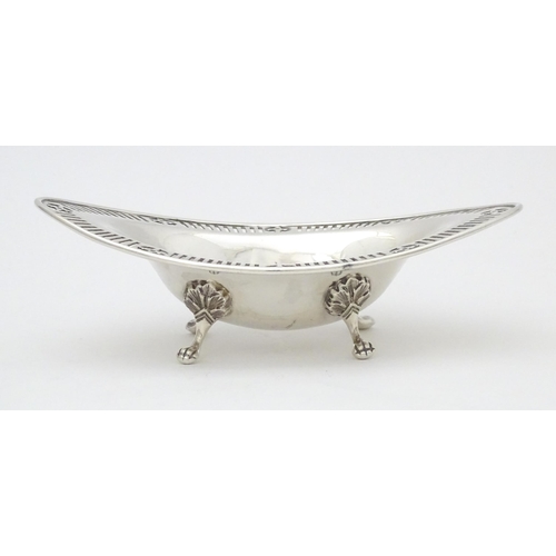 296 - A Victorian Scottish silver bon bon dish of ovoid form with pierced detail and raised on four feet. ... 