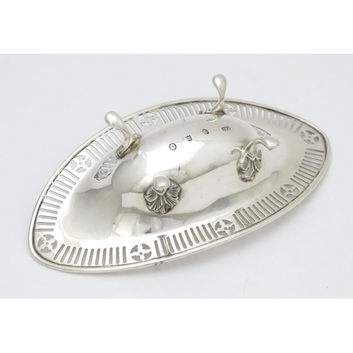 296 - A Victorian Scottish silver bon bon dish of ovoid form with pierced detail and raised on four feet. ... 