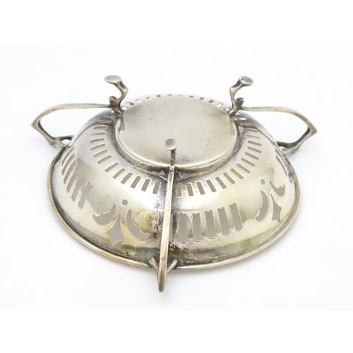 299 - A silver bon bon dish with pierced decoration and three handles raised on three feet. Hallmarked Bir... 