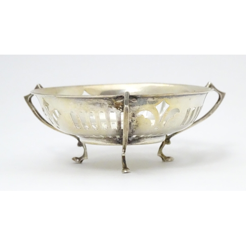 299 - A silver bon bon dish with pierced decoration and three handles raised on three feet. Hallmarked Bir... 