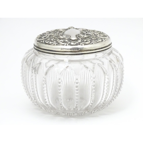 300 - A glass dressing table pot / powder bowl with embossed silver lid hallmarked Chester 1903, Importer ... 