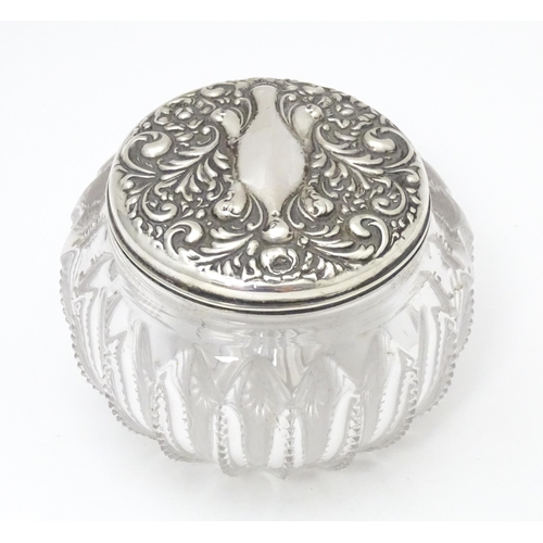 300 - A glass dressing table pot / powder bowl with embossed silver lid hallmarked Chester 1903, Importer ... 