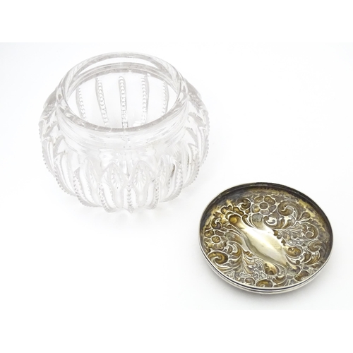 300 - A glass dressing table pot / powder bowl with embossed silver lid hallmarked Chester 1903, Importer ... 