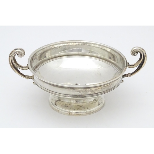 307 - A silver bon bon dish with twin handles. hallmarked Birmingham 1919 maker William Hutton and sons. A... 