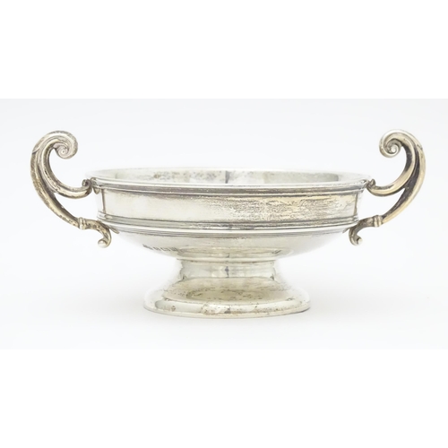 307 - A silver bon bon dish with twin handles. hallmarked Birmingham 1919 maker William Hutton and sons. A... 