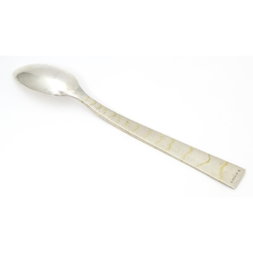 312 - A Queen Elizabeth II Scottish silver serving spoon with textured and gilt detail to handle, hallmark... 