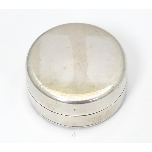 315 - An Egyptian white metal pill box with hieroglyphics decoration to lid.  Approx. 1 1/4