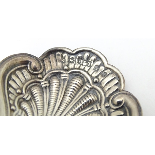 322 - A Victorian silver caddy spoon with shell formed bowl and scroll detail. Hallmarked Birmingham 1860 ... 