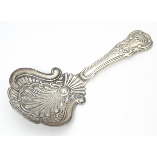 322 - A Victorian silver caddy spoon with shell formed bowl and scroll detail. Hallmarked Birmingham 1860 ... 