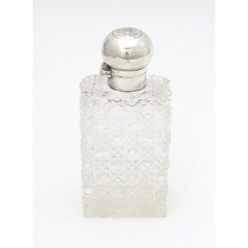 329 - A cut glass scent / perfume bottle with silver mount and lid hallmarked London 1903, maker Thomas Jo... 