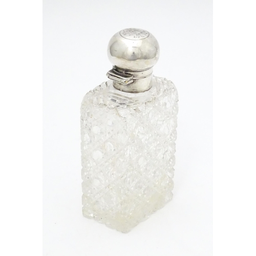 329 - A cut glass scent / perfume bottle with silver mount and lid hallmarked London 1903, maker Thomas Jo... 