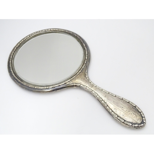 349 - A silver hand mirror and together with a silver topped glass dressing table pot. 2 1/2