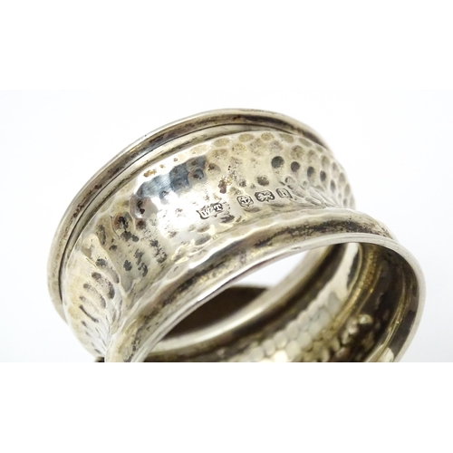 356 - Two napkin rings,  one with hammered decoration and hallmarked Birmingham 1907 maker W Turner, the o... 