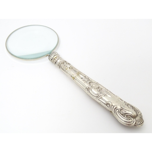 358 - A silver handled magnifying glass.  Approx. 6 1/4