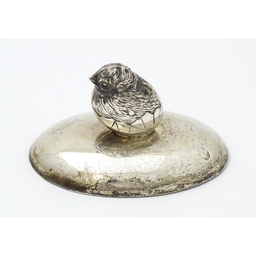 363 - A silver paperweight of ovoid form surmounted by model of a chick. Hallmarked Chester 1909 maker Sam... 