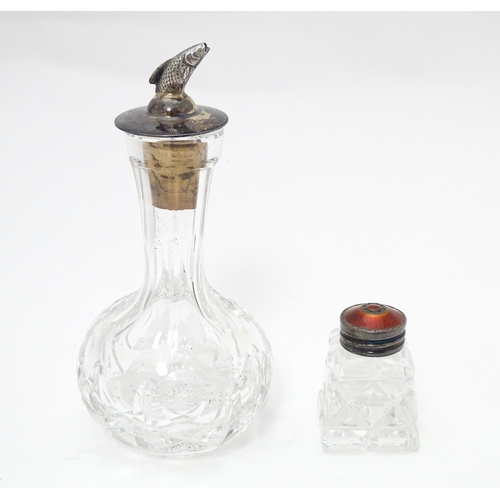 364 - A cut glass pepper with guilloche enamel lid marked Sterling. Together with a cut glass oil flask ha... 