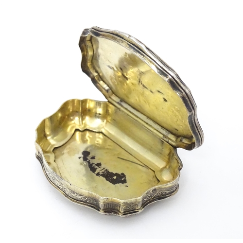 366 - A Continental silver gilt snuff box of shaped form with panels of mother of pearl, the lid decorated... 