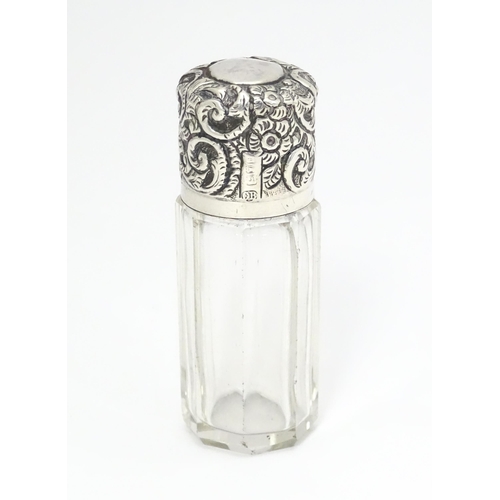 367 - A glass salts bottle with embossed silver lid, hallmarked London 1901 maker CB Approx. 3