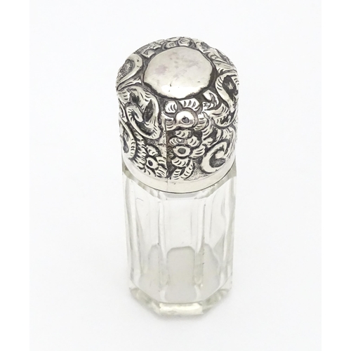 367 - A glass salts bottle with embossed silver lid, hallmarked London 1901 maker CB Approx. 3