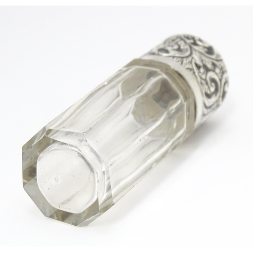 367 - A glass salts bottle with embossed silver lid, hallmarked London 1901 maker CB Approx. 3