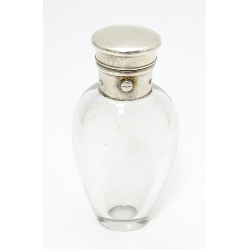 368 - A glass scent / perfume bottle with white metal lid opening to revival Crown mark titled WES. Approx... 