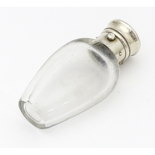 368 - A glass scent / perfume bottle with white metal lid opening to revival Crown mark titled WES. Approx... 