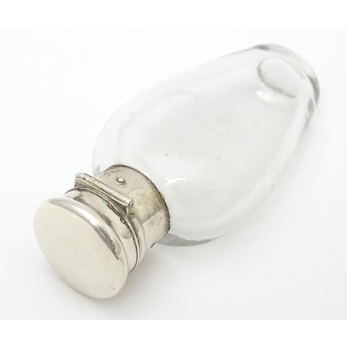 368 - A glass scent / perfume bottle with white metal lid opening to revival Crown mark titled WES. Approx... 