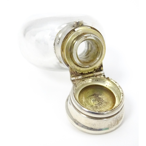 368 - A glass scent / perfume bottle with white metal lid opening to revival Crown mark titled WES. Approx... 