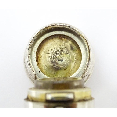 368 - A glass scent / perfume bottle with white metal lid opening to revival Crown mark titled WES. Approx... 