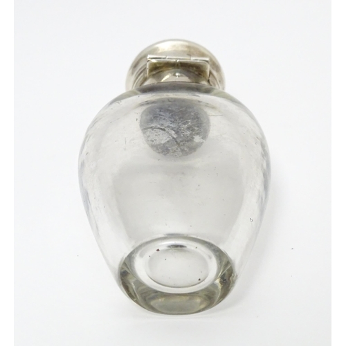 368 - A glass scent / perfume bottle with white metal lid opening to revival Crown mark titled WES. Approx... 