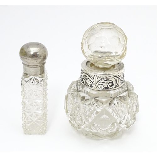 386 - A cut glass scent / perfume bottle with white metal collar having acanthus scroll decoration togethe... 