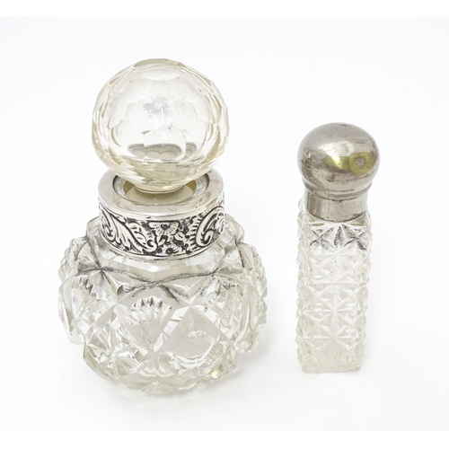 386 - A cut glass scent / perfume bottle with white metal collar having acanthus scroll decoration togethe... 