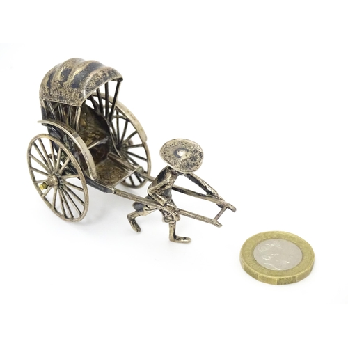 399 - A Chinese export silver model of a man pulling a rickshaw, numbered 205 and stamped with makers mark... 