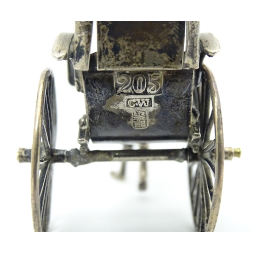 399 - A Chinese export silver model of a man pulling a rickshaw, numbered 205 and stamped with makers mark... 