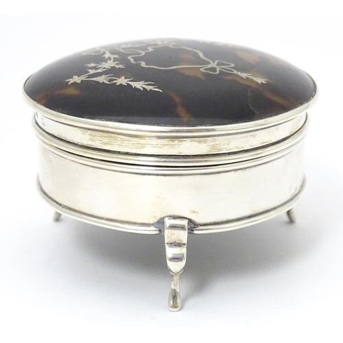 402 - A silver ring box raised on three feet, the tortoiseshell lid with piquework decoration, hallmarked ... 