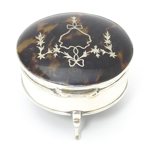 402 - A silver ring box raised on three feet, the tortoiseshell lid with piquework decoration, hallmarked ... 