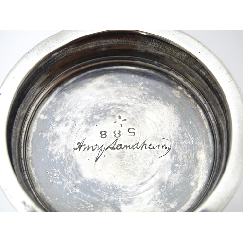 404 - An Arts & Crafts silver christening mug with hammered decoration, banded spherical ball detail and b... 