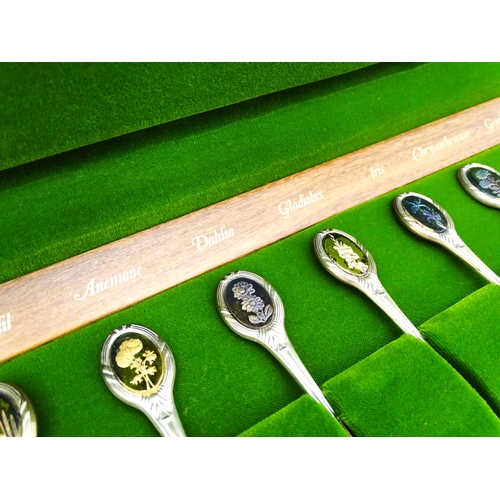 415 - A set of twelve silver Royal Horticultural Flower spoons, each decorated with various floral detail,... 